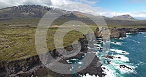 Lava cliffs at Snaefellsnes, Iceland, Snaefellsjokull volcano in the back