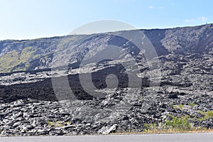 Lava fields on the Big Island in Hawaii with the Pacific Ocean in the background