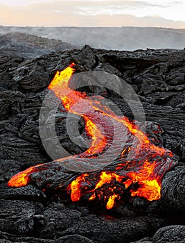 Hawaii - lava emerges from a column of the earth photo