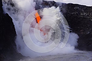 Lava flowing out of cliff suround with white cloud steam