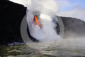 Lava flowing out of cliff suround with white cloud steam