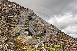 Lava rock formations in the slope of Eldborg volcano crater in Vesturland region of Iceland photo