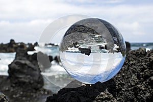 Surf Breaking on Lava Rock Captured in Glass Ball