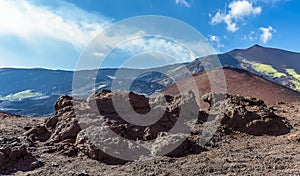 Lava rocks and secondary cones looking towards the summit of  Mount Etna, Sicily