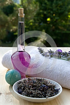 Lavander branch on the towel with lavender oil bo