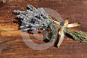 Lavander oil with flower on wooden background