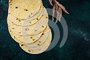Lavash flat bread on green background
