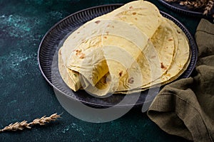Lavash flat bread on green background