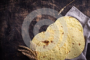 Lavash flat bread on green background