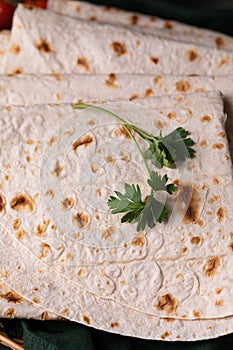 Lavash rolled on a wooden background, thin traditional oriental bread, Armenian flatbread macro