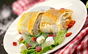 Lavash rolls with meet, vegetables and cheese served with green