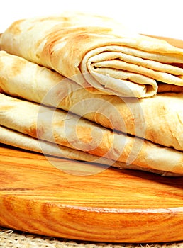 Lavash, tortilla wrap Bread on the cutting board on white