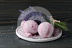 Lavender bath bombs and flowers on dark wooden table