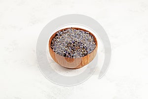 Lavender bud dry flowers in wooden bowl. Purple herbal tea with natural dried lavender flowers