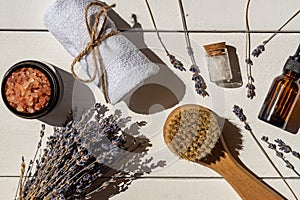 Lavender cosmetics - natural lavender essential oil with massaging brash, sea salt and towel. Aromatherapy, spa, wellness