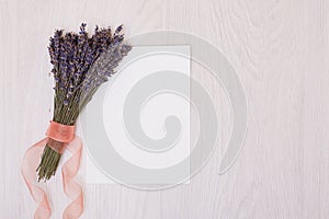 Lavender desk with flowers on background top view mock up.White paper postcard