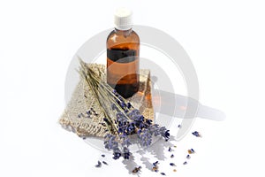 Lavender essential oil with lavender plants on a white background