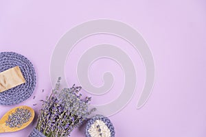 Lavender flowers are arranged on a purple background.