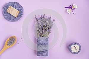 Lavender flowers are arranged on a purple background.