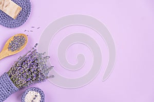 Lavender flowers are arranged on a purple background.