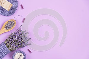 Lavender flowers are arranged on a purple background.