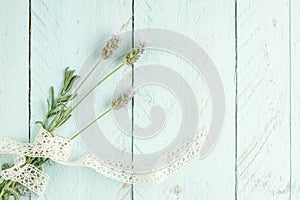 Lavender flowers on a green wooden background decorated with ribbon