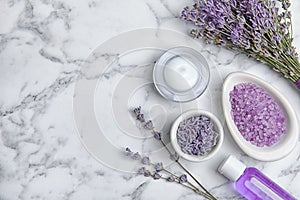 Lavender flowers and natural cosmetic products on marble background