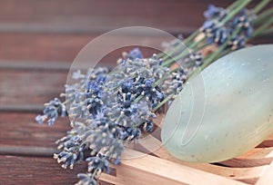 Lavender flowers and soap on wooden tale