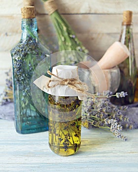 Lavender flowers, tincture bottles and lavender oil jars, on wooden background