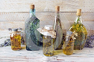 Lavender flowers, tincture bottles and lavender oil jars, on wooden background