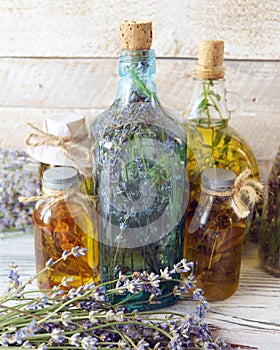 Lavender flowers, tincture bottles and lavender oil jars, on wooden background