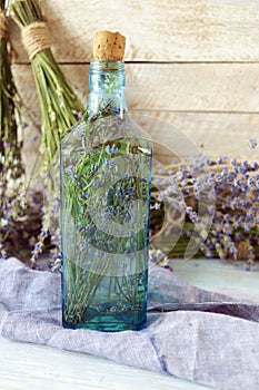 Lavender flowers, tincture bottles and lavender oil jars, on wooden background