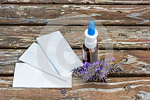 Lavender, handkerchiefs and nasal spray for immediate relief of cold as a wooden background