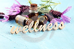 Lavender herbal oil and lavender flowers. bottle of lavender massage oil for aromatherapy treatment and wellness letters made of