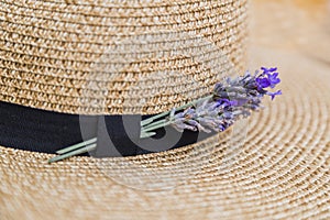 Lavender inserted in black ribbon on wicker straw flaxen hat photo