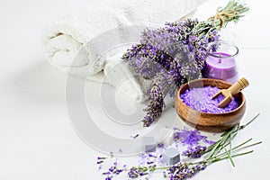 Lavender flowers and lavender salt, soap, candle and white towels for spa aroma therapy