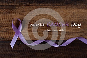 Lavender ribbon symbol of all type of cancer on wooden table