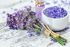 lavender\'s spa products with dried lavender flowers on a wooden table.