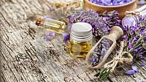 lavender\'s spa products with dried lavender flowers on a wooden table.