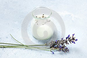 A lavender scented candle with lavender flowers and a place for text