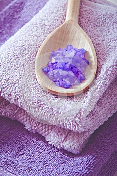 Lavender scented purplr bath salt in a wooden spoon photo