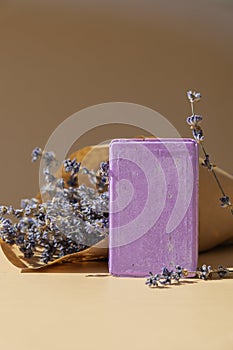 Lavender soap on beige background with copy space for your text. Advertisement template mock up. Skincare homemade