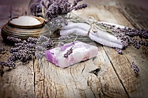 Lavender soap and scented salt on rustic wooden background