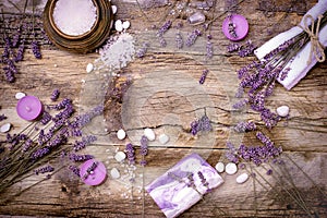 Lavender soap, scented salt and spa stones on rustic table