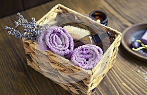 Lavender spa composition, home spa day with lavender products, top view of spa still life towels, lavender oil, natural soap, bath