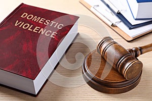 Law book and gavel on wooden table. Protection from domestic violence