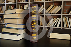 Law book about wills and trusts on the desk.