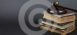 Law book with a wooden judges gavel on table