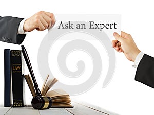 Law book and wooden judges gavel on table in a courtroom or law enforcement office. Lawyer Hands holding business card