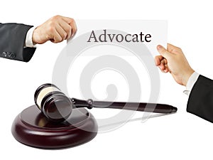 Law book and wooden judges gavel on table in a courtroom or law enforcement office. Lawyer Hands holding business card